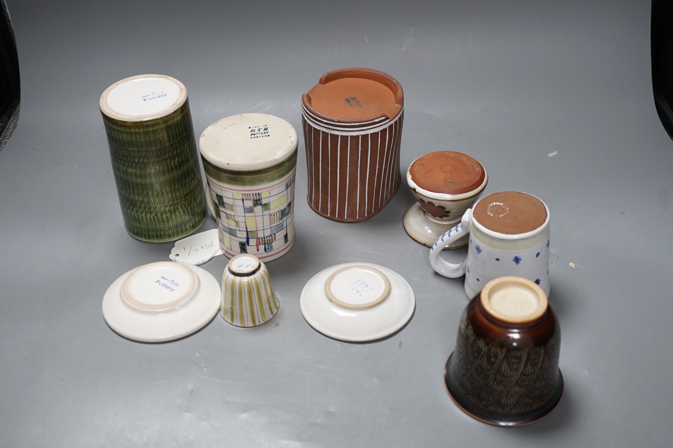 Seven pieces of Rye pottery to include a Dennis Townsend marked mosaic tankard, another small star and dot mug, two sgraffito pin dishes, a Jim Elliot marked terracotta pot, a cylindrical brush pot and a yellow striped t